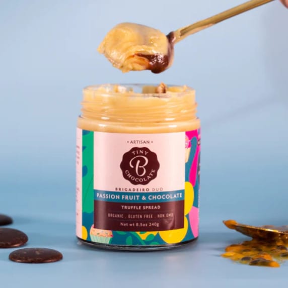 jar of passion fruit and chocolate spread with spoon dollup